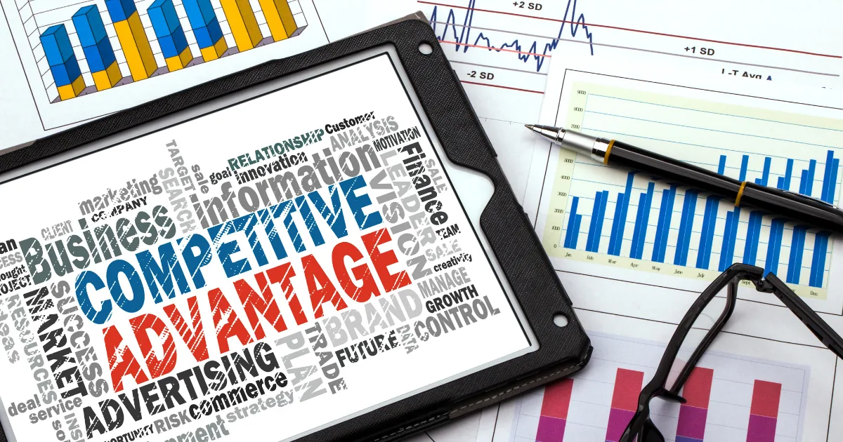 Business analytics charts and graphs with competitive advantage word cloud on tablet showing SMB workflow redesign strategy